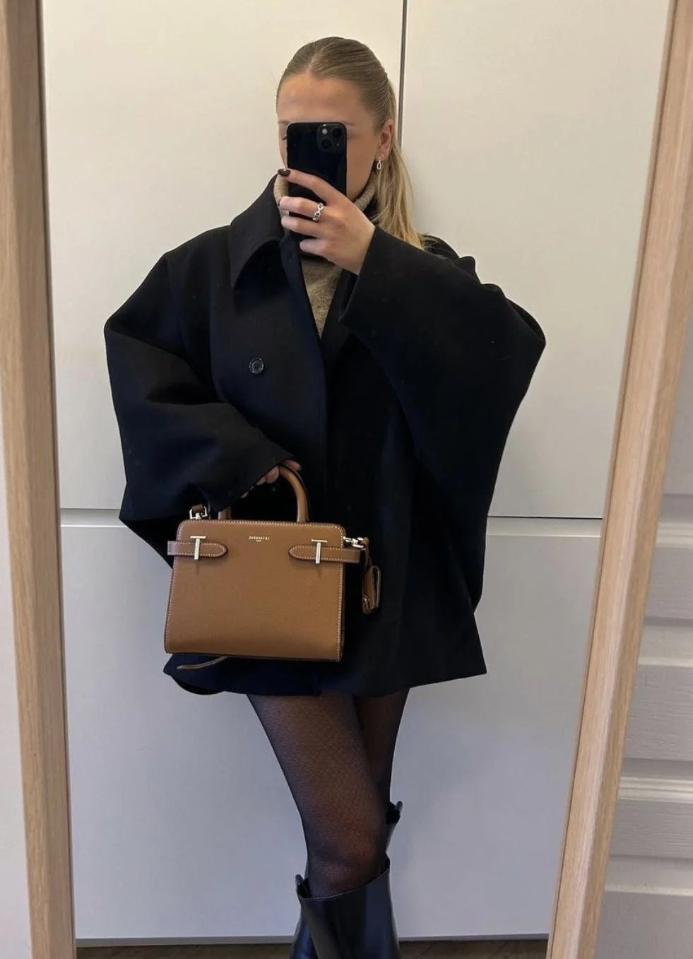 Women's oversized coat featuring wide lapels, button closure, and soft fabric blend for comfort and style.