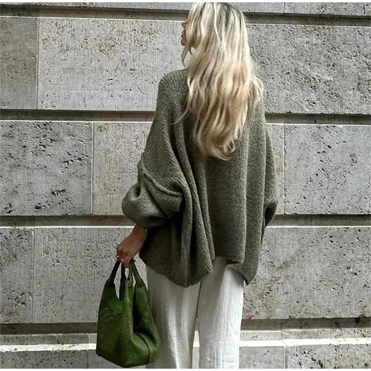 Women's oversized cozy pullover sweater made from soft knit fabric, featuring long sleeves and a relaxed fit for comfort.