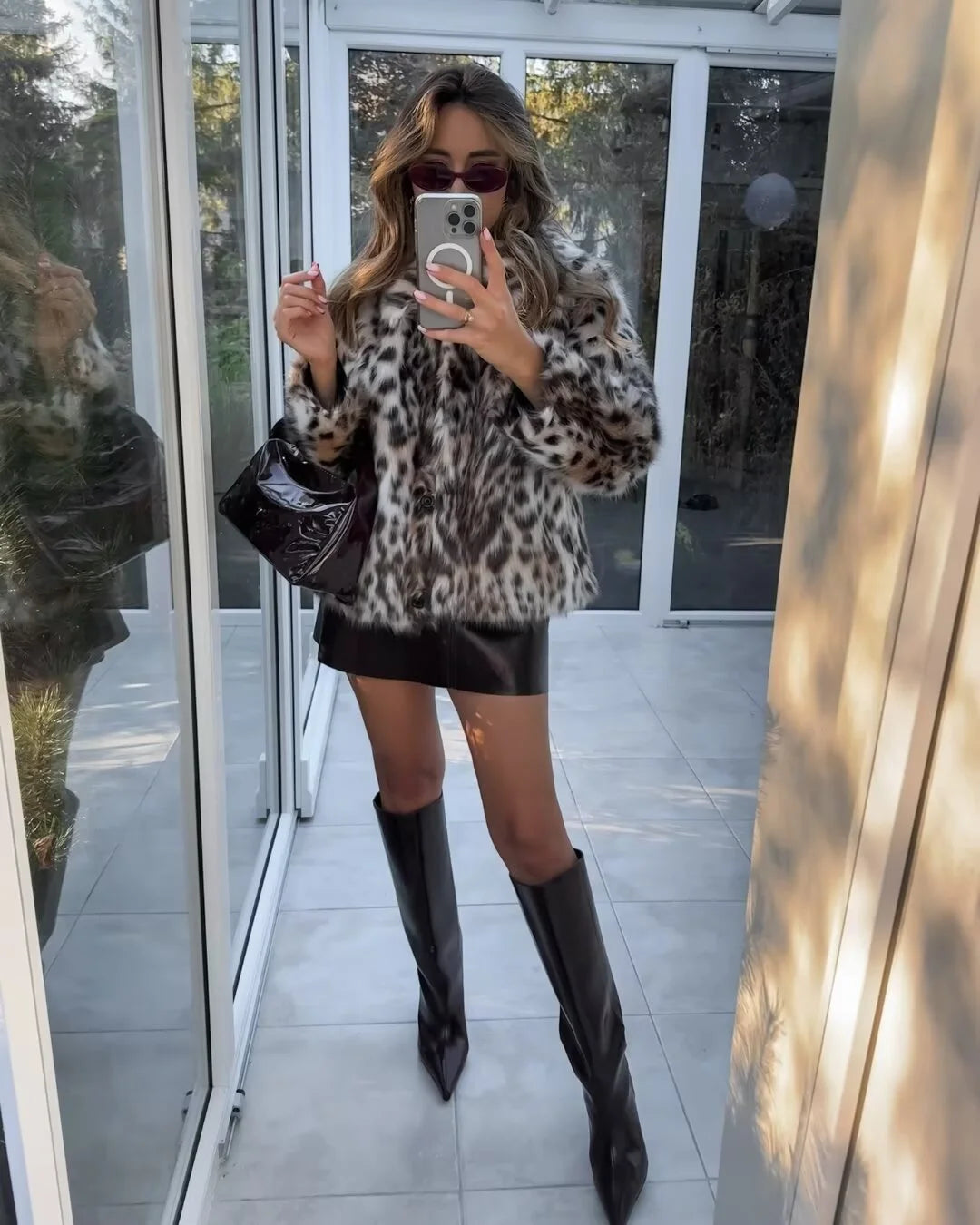 Women's oversized faux fur jacket featuring a stylish animal pattern, soft texture, and cozy, relaxed fit for everyday wear.