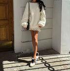 Women's oversized fluffy sweater featuring an off-shoulder design, crafted from soft, cozy fabric for comfort and style.