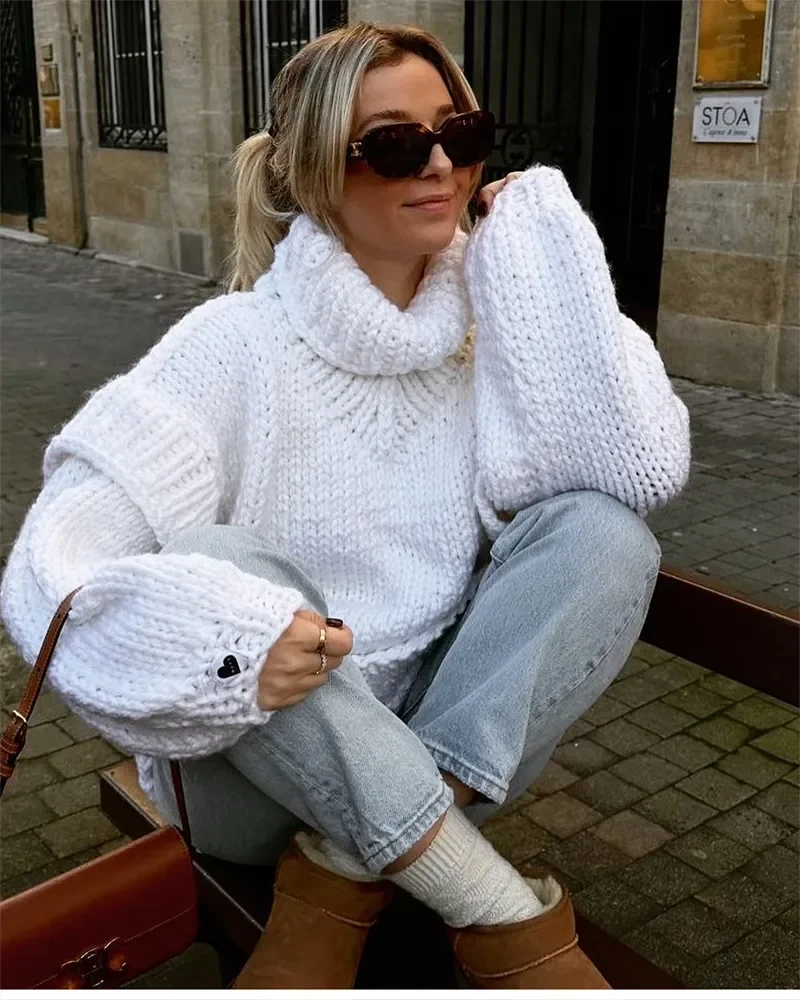 Women's oversized knit sweater dress in soft, warm fabric features a cozy turtleneck and relaxed fit for comfortable…