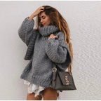 Women’s oversized knit sweater dress with turtleneck, made from soft acrylic blend, featuring a relaxed fit and cozy texture.