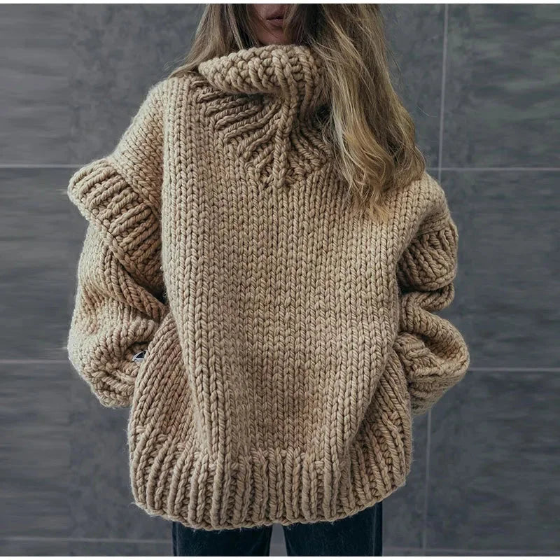 Women's oversized knit sweater dress with a cozy turtleneck, made from soft, warm fabric for comfort and style.