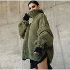 Women's oversized knit sweater dress with turtleneck, crafted from soft yarn for warmth and comfort, featuring a relaxed fit.