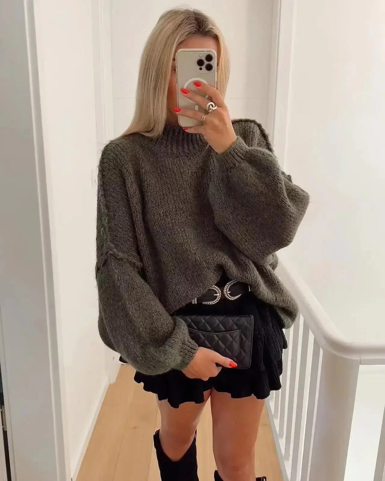 Women's oversized knit sweater featuring cozy balloon sleeves, crafted from soft acrylic yarn for warmth and comfort.