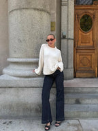 Women's oversized knit sweater with long sleeves, made from soft, breathable fibers, featuring a relaxed fit and ribbed…