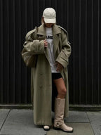 Women's oversized long trench coat made of soft cotton, featuring wide lapels and a belt for adjustable fit and style.