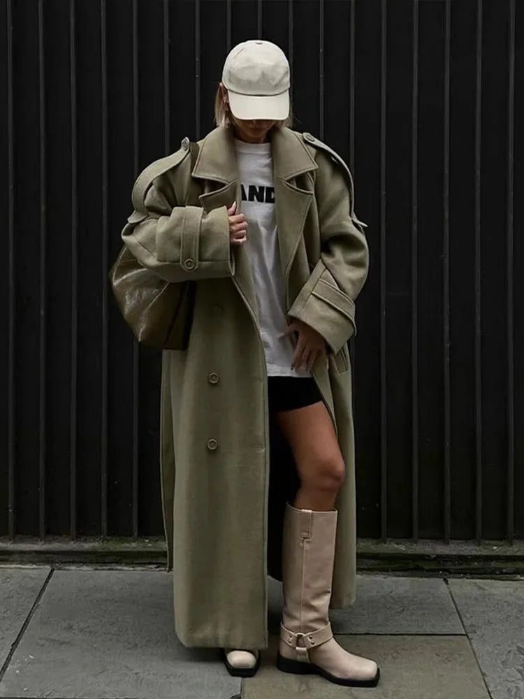 Women's oversized long trench coat made of soft cotton, featuring wide lapels and a belt for adjustable fit and style.