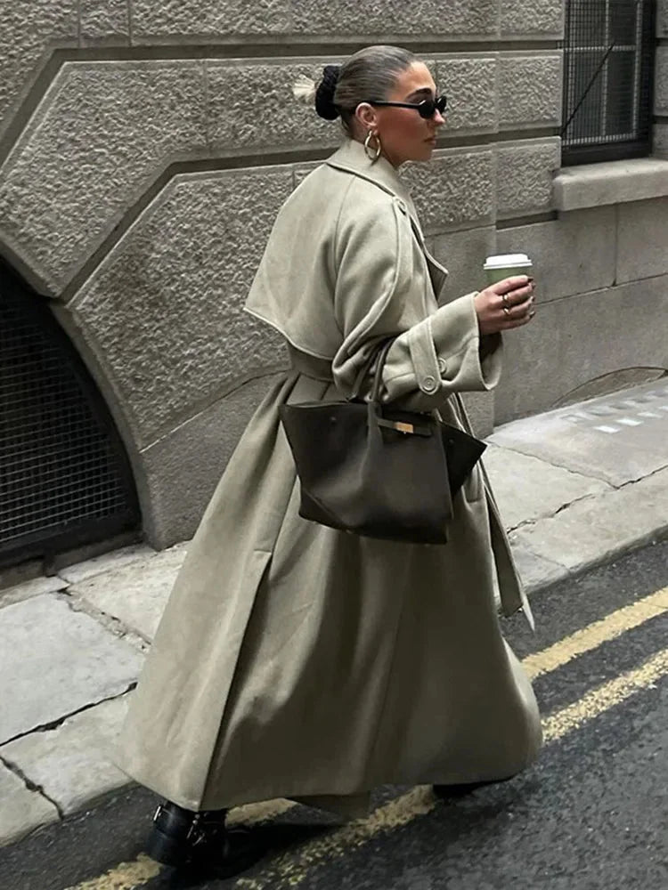 Women's oversized long trench coat with wide lapels, crafted from lightweight fabric, perfect for layering in cooler weather.