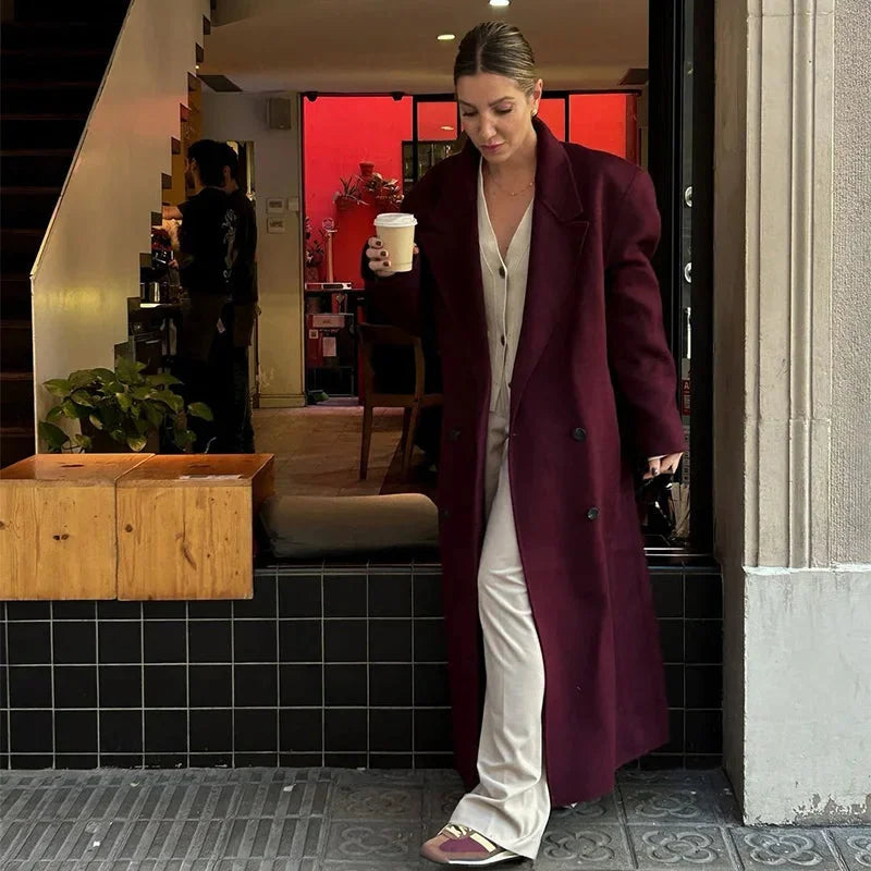 Women's oversized long trench coat with wide lapels, made from breathable cotton, featuring a belted waist and side pockets.