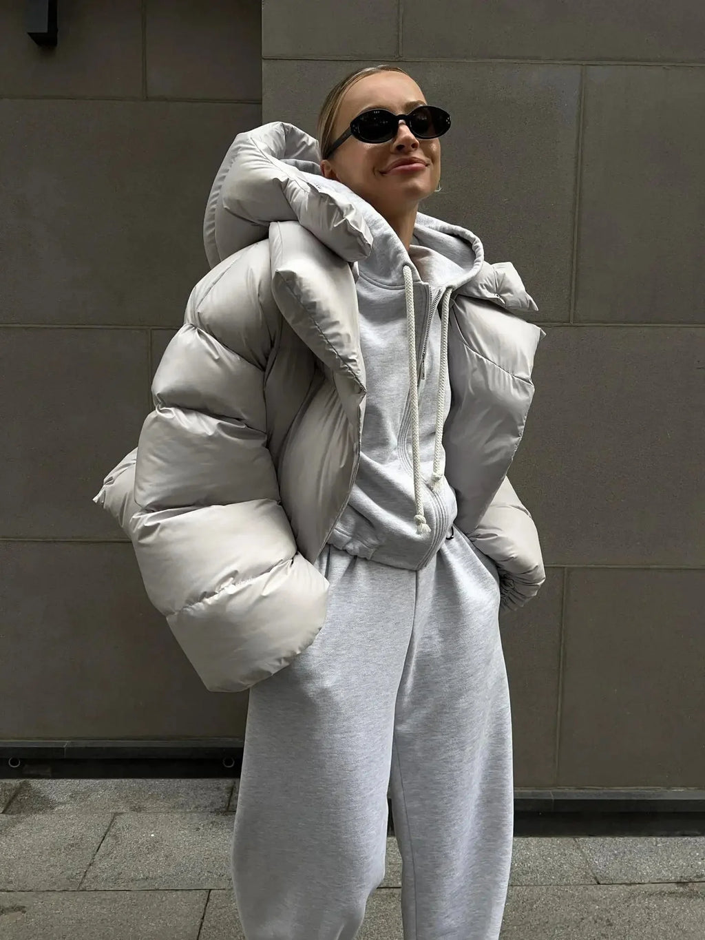 Women's oversized puffer coat in durable nylon, featuring a high collar and spacious design for comfort and warmth.