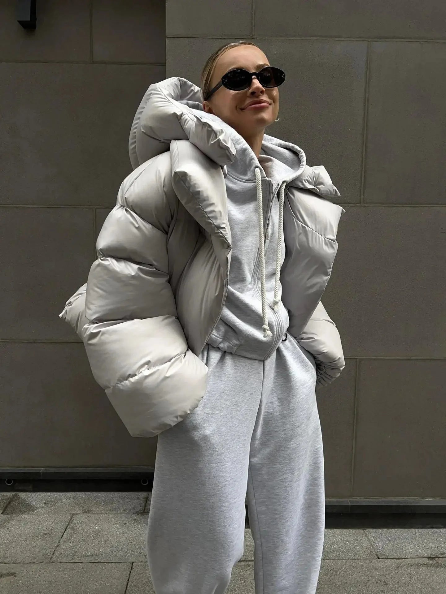 Women's oversized puffer coat in durable nylon, featuring a high collar and spacious design for comfort and warmth.