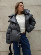 Women's oversized puffer coat with high collar, featuring a quilted design and durable nylon exterior for warmth and comfort.