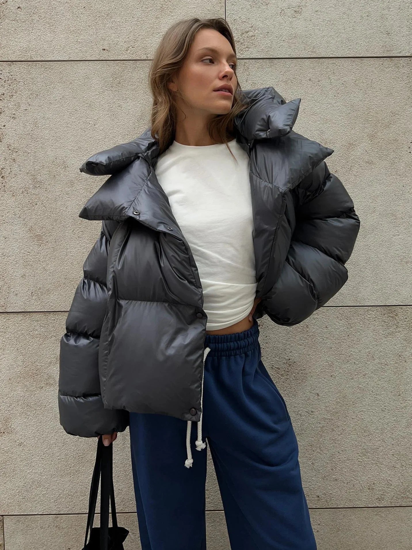 Women's oversized puffer coat with high collar, featuring a quilted design and durable nylon exterior for warmth and comfort.