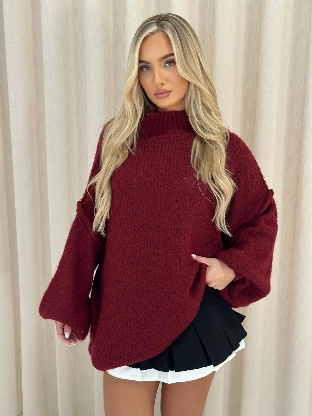 Soft women's oversized pullover sweater with a cozy high neckline, crafted from warm knit fabric for comfort and style.