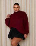 Women's oversized pullover sweater in soft knit, featuring a cozy high neckline and relaxed fit for comfortable wear.