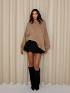 Cozy women's oversized pullover sweater with a high neckline, made from soft knit fabric for warmth and comfort in chilly…