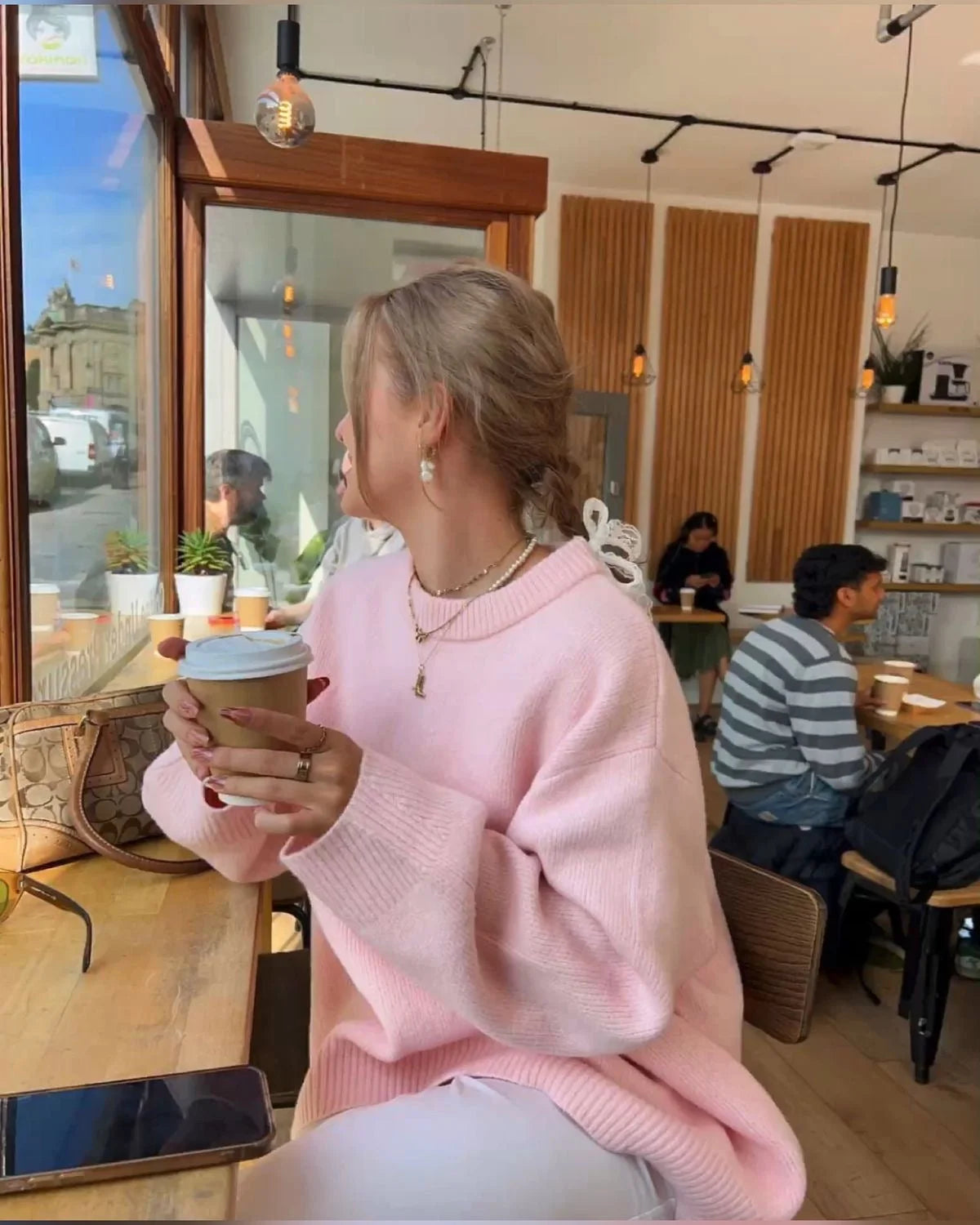 Women's oversized soft pink sweater, featuring long sleeves and a cozy knit fabric for a relaxed, casual look.