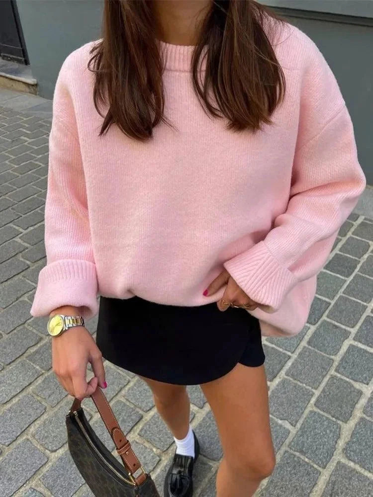 Soft pink oversized sweater for women, featuring long sleeves and a cozy knit design for warmth and comfort.