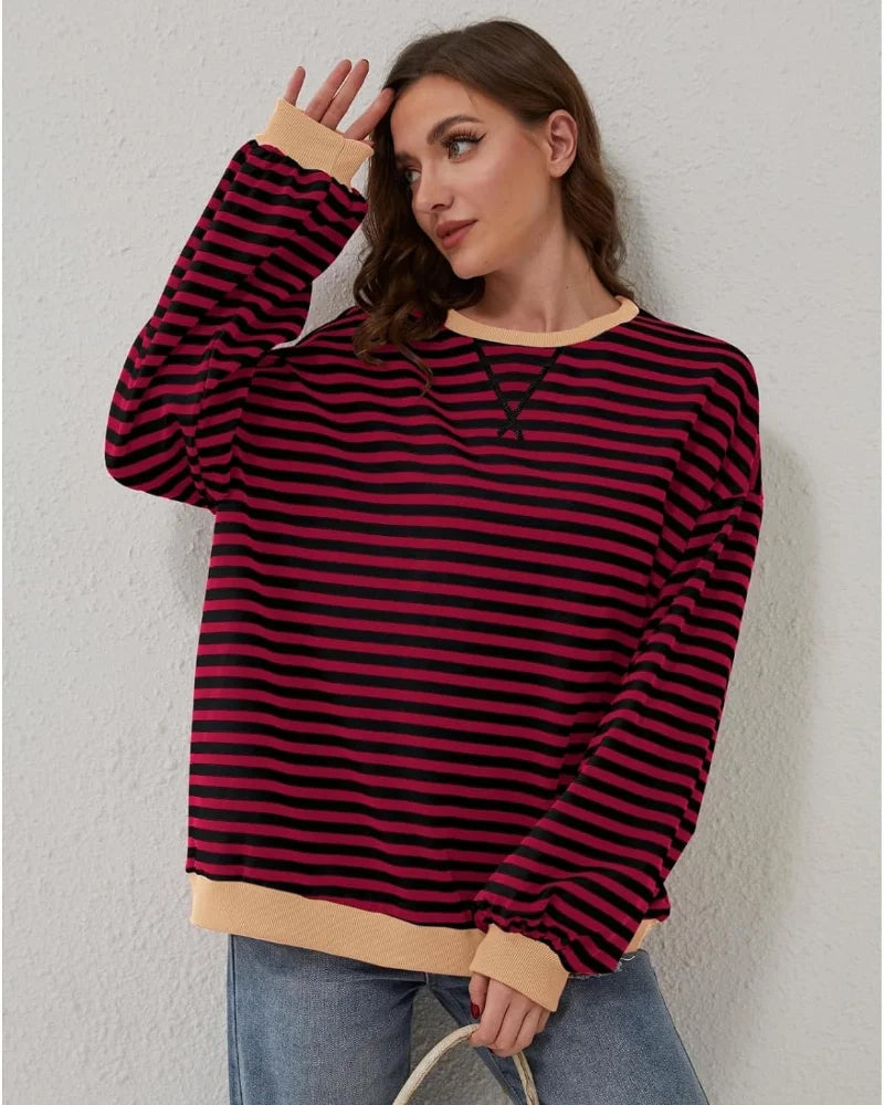 Women's oversized striped long sleeve sweatshirt in soft cotton blend, featuring a relaxed fit and colorful horizontal…