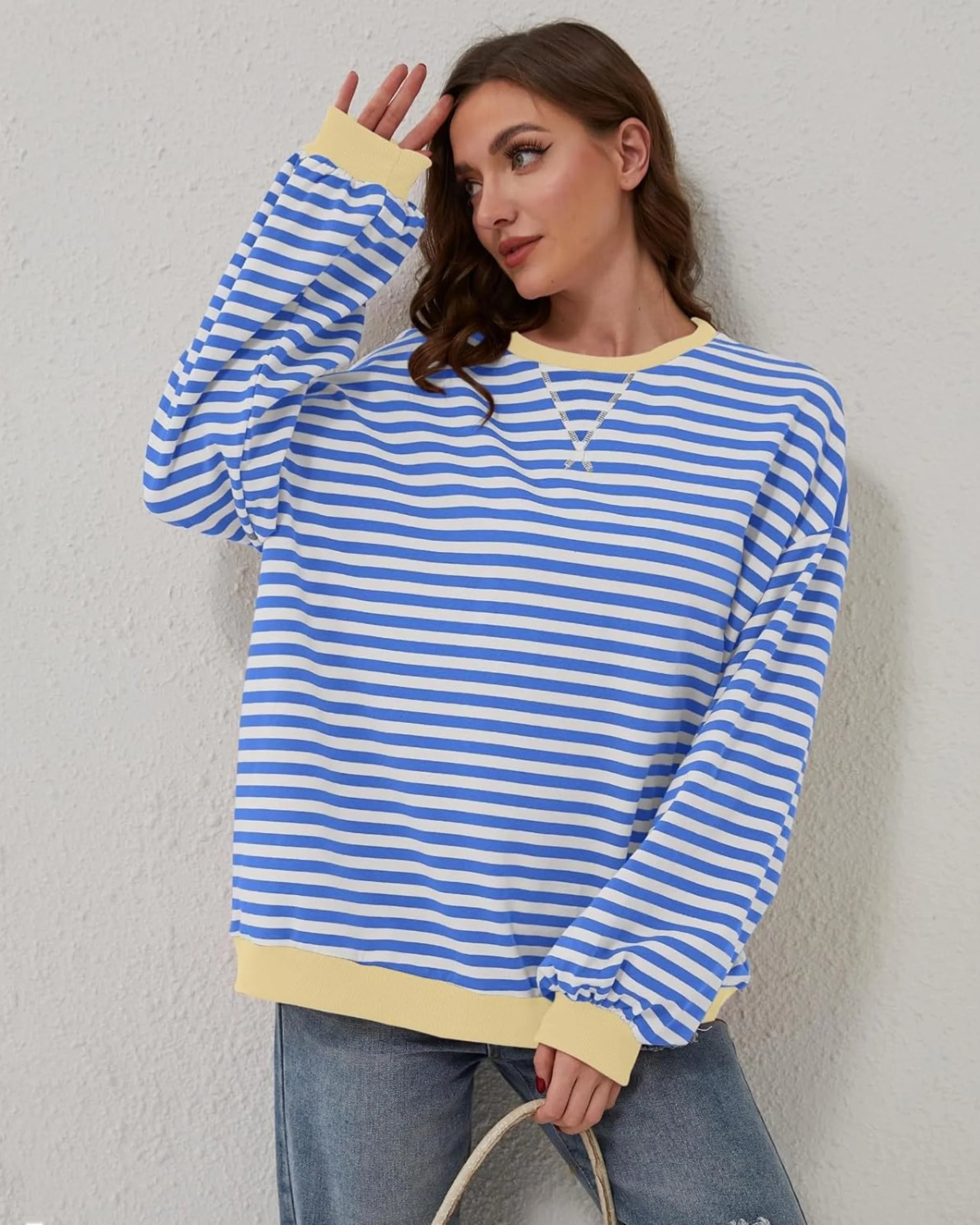 Women's oversized striped long sleeve sweatshirt made of soft cotton blend with a relaxed fit and classic crew neck design.