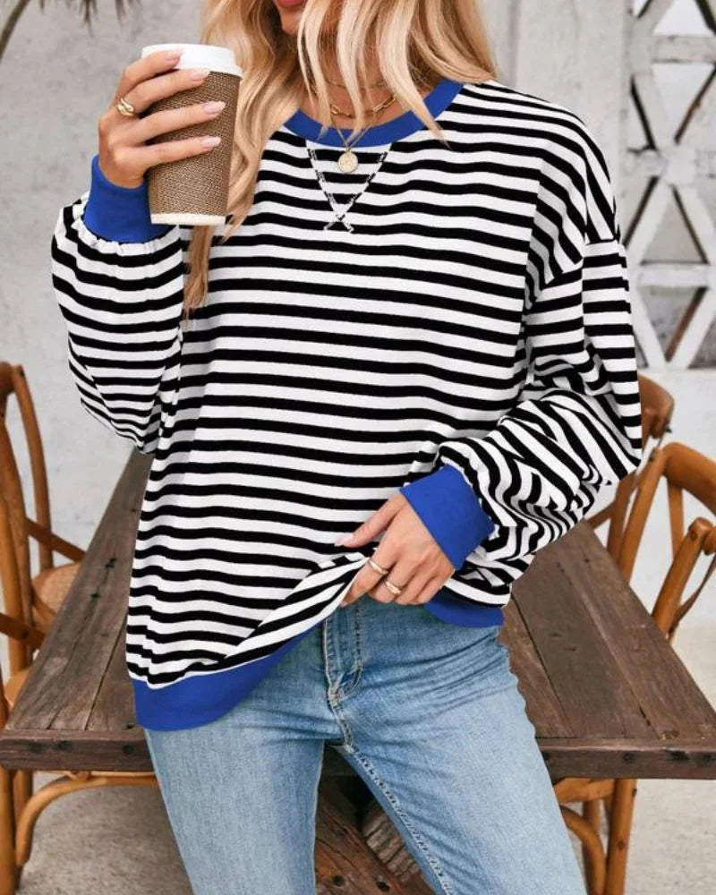 Women's oversized striped long sleeve sweatshirt made from soft cotton blend, featuring a relaxed fit and crew neckline…