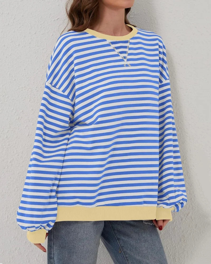 Women's oversized striped long sleeve sweatshirt made from soft cotton blend with a relaxed fit and wide cuffs.