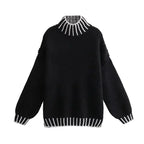 Women's oversized sweater featuring soft knit fabric and striped details on sleeves for a comfortable and casual look.