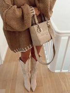 Woman's oversized sweater in soft knit, featuring horizontal stripes and a relaxed fit for comfort and style.