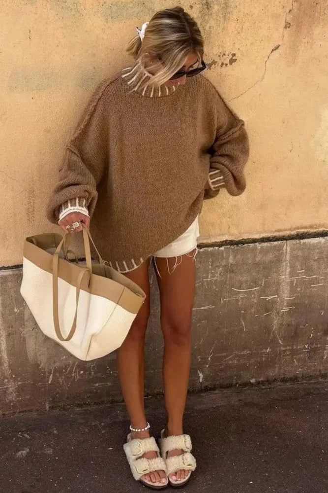 Oversized women's sweater featuring striped details, made from soft cotton blend for a comfortable and relaxed fit.
