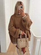 Women's oversized sweater featuring striped details, made from soft knit fabric for comfort and a relaxed fit.