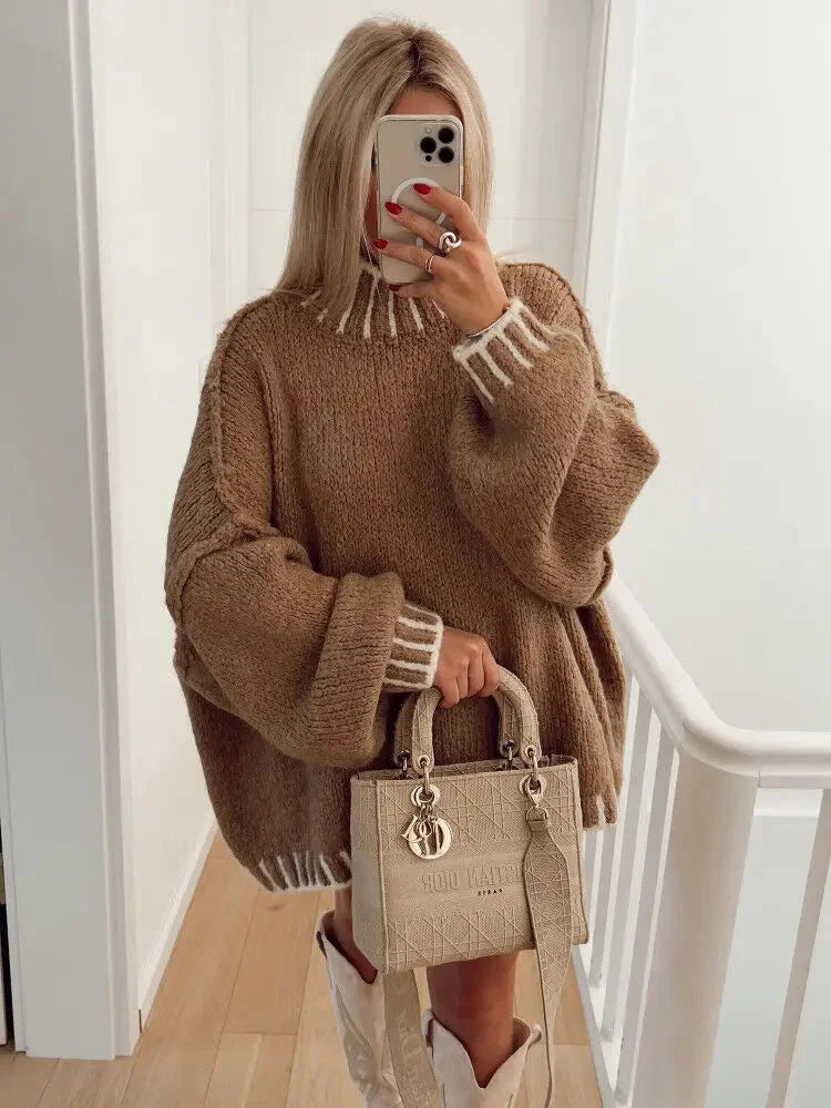 Women's oversized sweater featuring striped details, made from soft knit fabric for comfort and a relaxed fit.