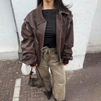Women's oversized velvet bomber jacket with zip front, featuring soft texture and relaxed fit for comfortable layering.