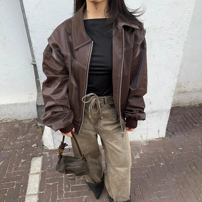 Women's oversized velvet bomber jacket with zip front, featuring soft texture and relaxed fit for comfortable layering.