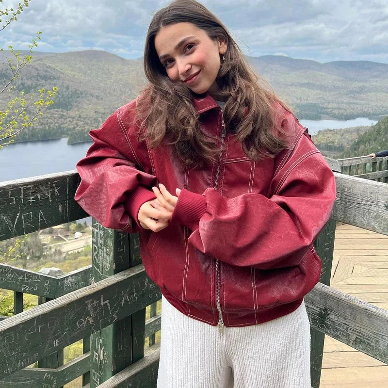 Women's oversized velvet bomber jacket with zip front, featuring a soft texture and relaxed fit for casual comfort.