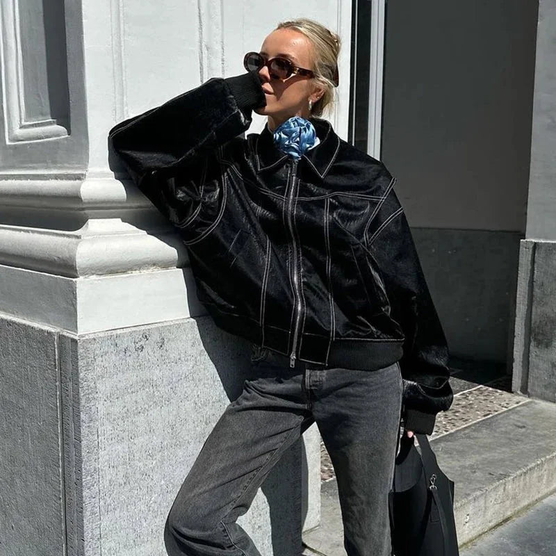Women's oversized velvet bomber jacket in deep green, featuring a zip front and ribbed cuffs for a comfortable fit.