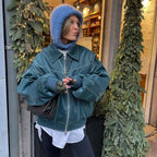Women's oversized bomber jacket in soft velvet, featuring a zip front and casual design, perfect for layering in cooler…