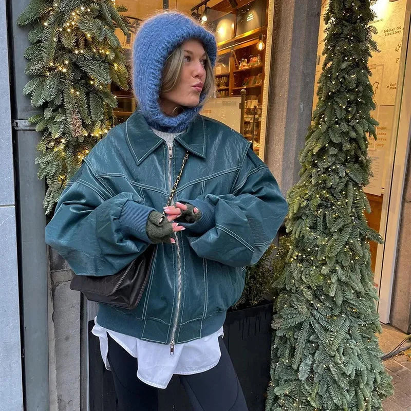 Women's oversized bomber jacket in soft velvet, featuring a zip front and casual design, perfect for layering in cooler…