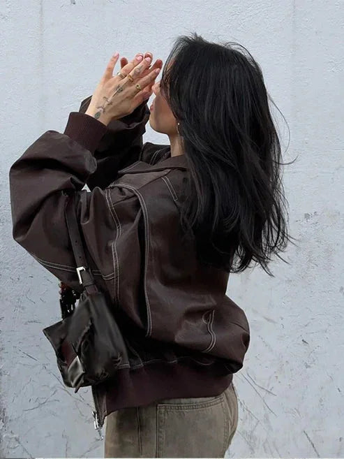 Women's oversized velvet bomber jacket featuring a zip front, soft texture, and a relaxed fit for comfortable layering.