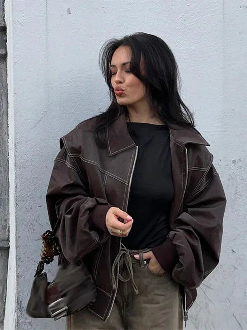 Women's oversized velvet bomber jacket featuring a zip front, soft texture, and a casual, relaxed fit for everyday wear.