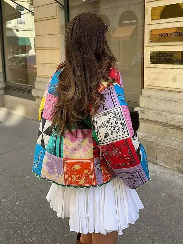 Colorful patchwork women's jacket with long sleeves, featuring a blend of fabric textures and vibrant patterns.