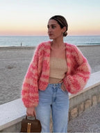 Women’s patchwork crochet sweater featuring textured sleeves, crafted from soft yarn for added warmth and style.