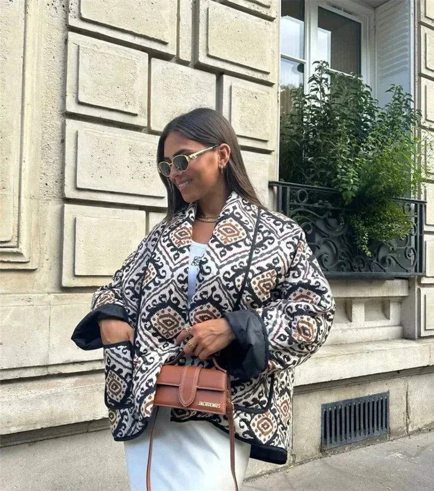 Women's patterned jacket featuring wide sleeves, crafted from soft cotton-blend fabric with a vibrant, abstract print.