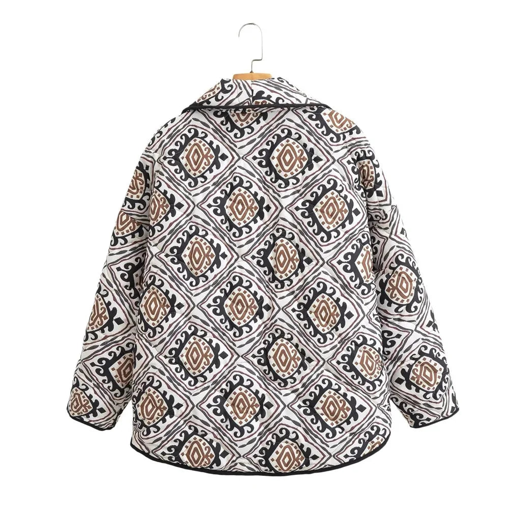 Women's patterned jacket featuring wide sleeves, made from lightweight fabric with a vibrant geometric design.