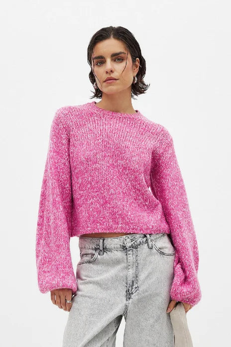 Women's pink backless pullover with long sleeves, crafted from soft knit fabric, featuring a stylish open back design.