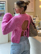 Women's backless pink pullover with long sleeves, crafted from soft cotton blend fabric for comfort and breathability.