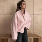 Women's pink oversized jacket made of soft, cozy fabric with a relaxed fit and large front pockets for added comfort.