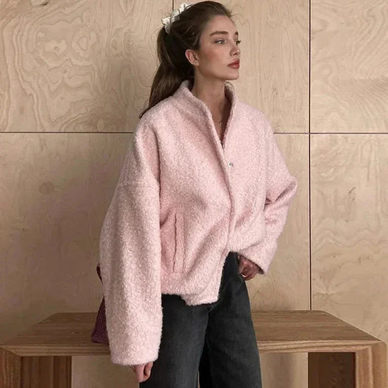 Women's pink oversized jacket made of soft, cozy fabric with a relaxed fit and large front pockets for added comfort.