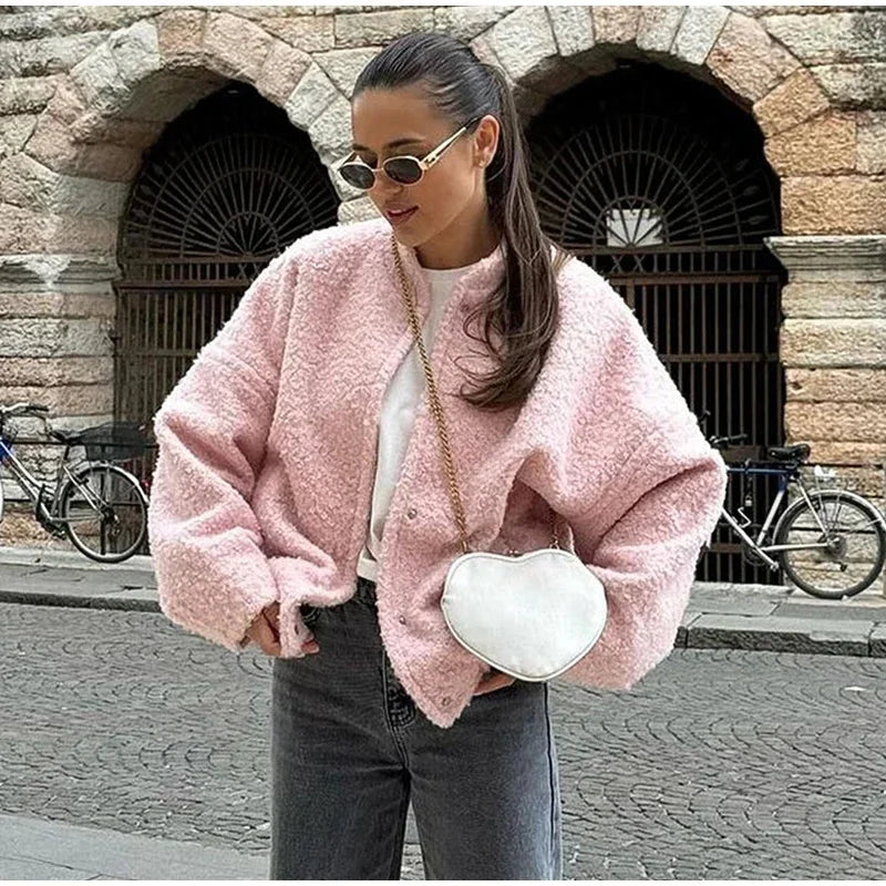Women's oversized pink jacket featuring cozy texture and relaxed fit, perfect for layering on cool days.
