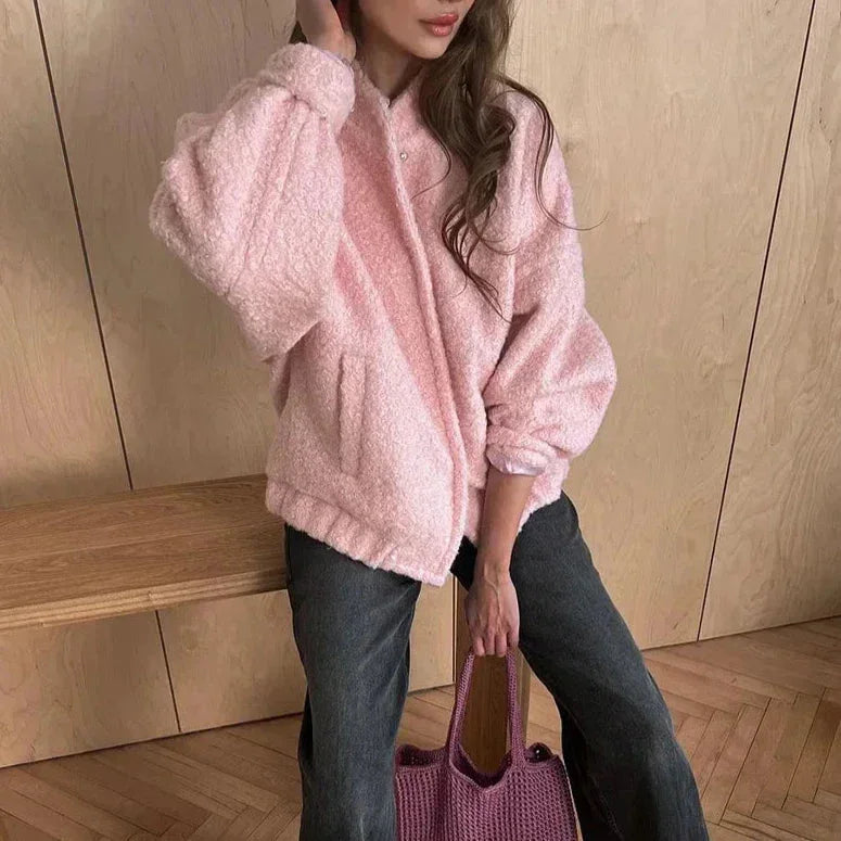 Women's pink oversized jacket made from cozy textured fabric, featuring a relaxed fit and comfortable long sleeves.